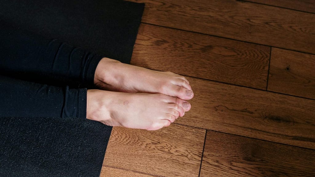 Feet hanging off the end of a yoga mat. My monthly yoga progress looks nothing like this.