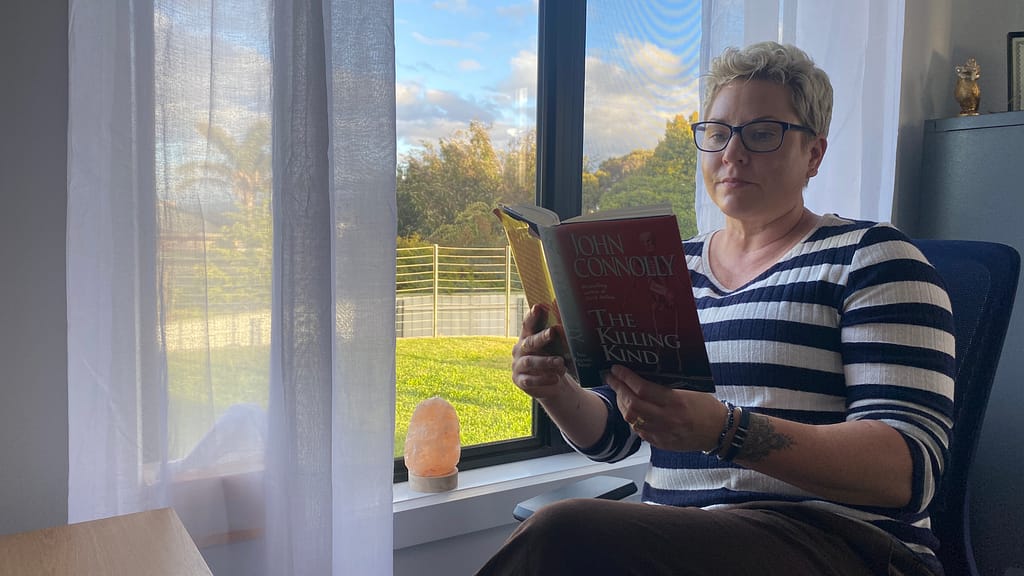 Em sits in her office by the window, pretending to read The Killing Kind by John Connolly. Another cracker from Wendy's bookshelf.