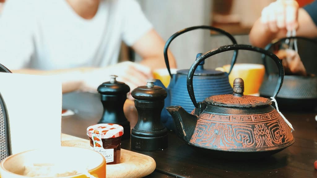 Friends sit together for a cup of tea