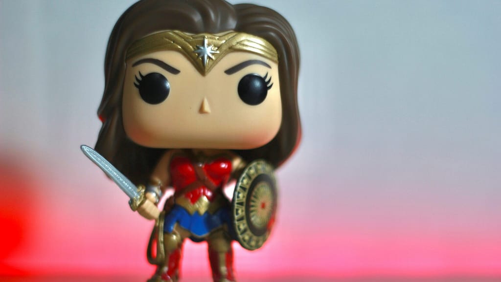 A Wonder Woman figurine looking fierce. She doesn't like midlife myths.