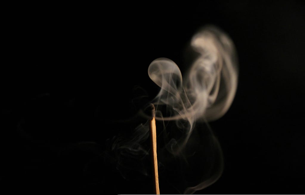 Smoke rises from an extinguished match. A metaphor for outgrowing your passion.