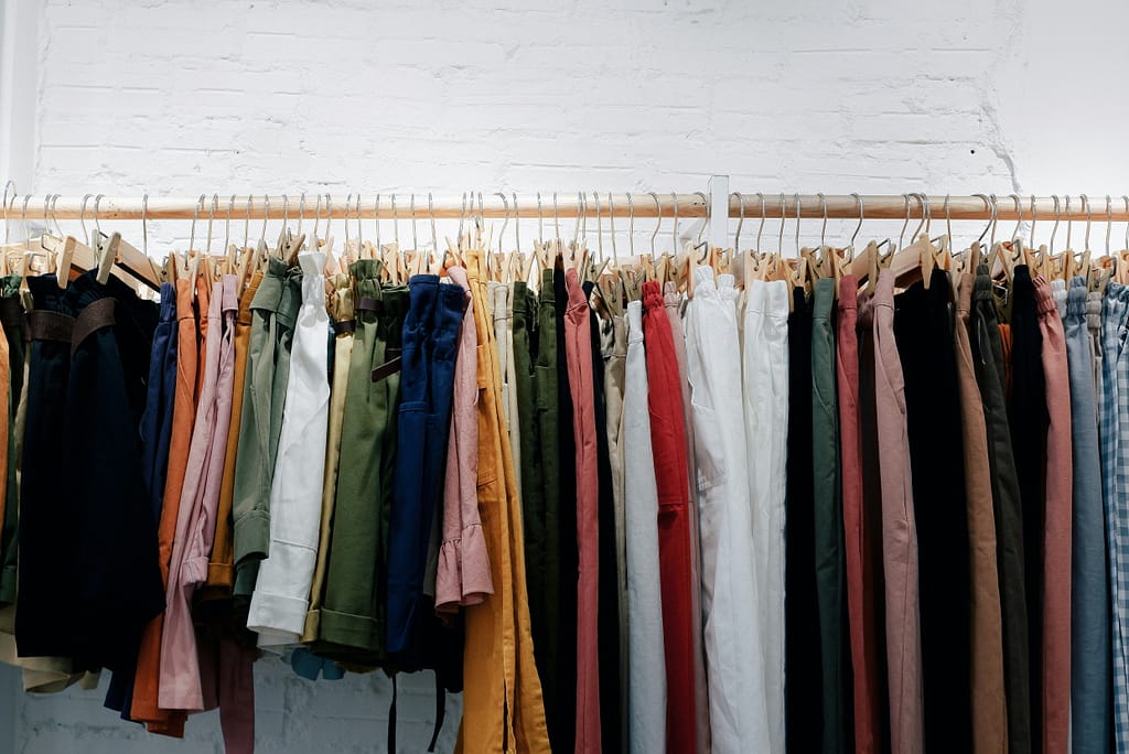 Clothes on a rack. Our wardrobes are often filled with the clothes we outgrow on our journey to midlife.