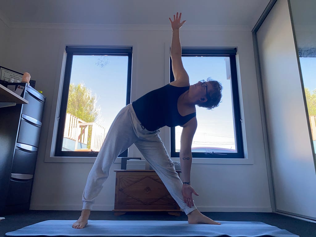 Em holds a Triangle pose for her February Yoga Update. It forms part of the Moon Salute, but she's doing it during the day for photography reasons.