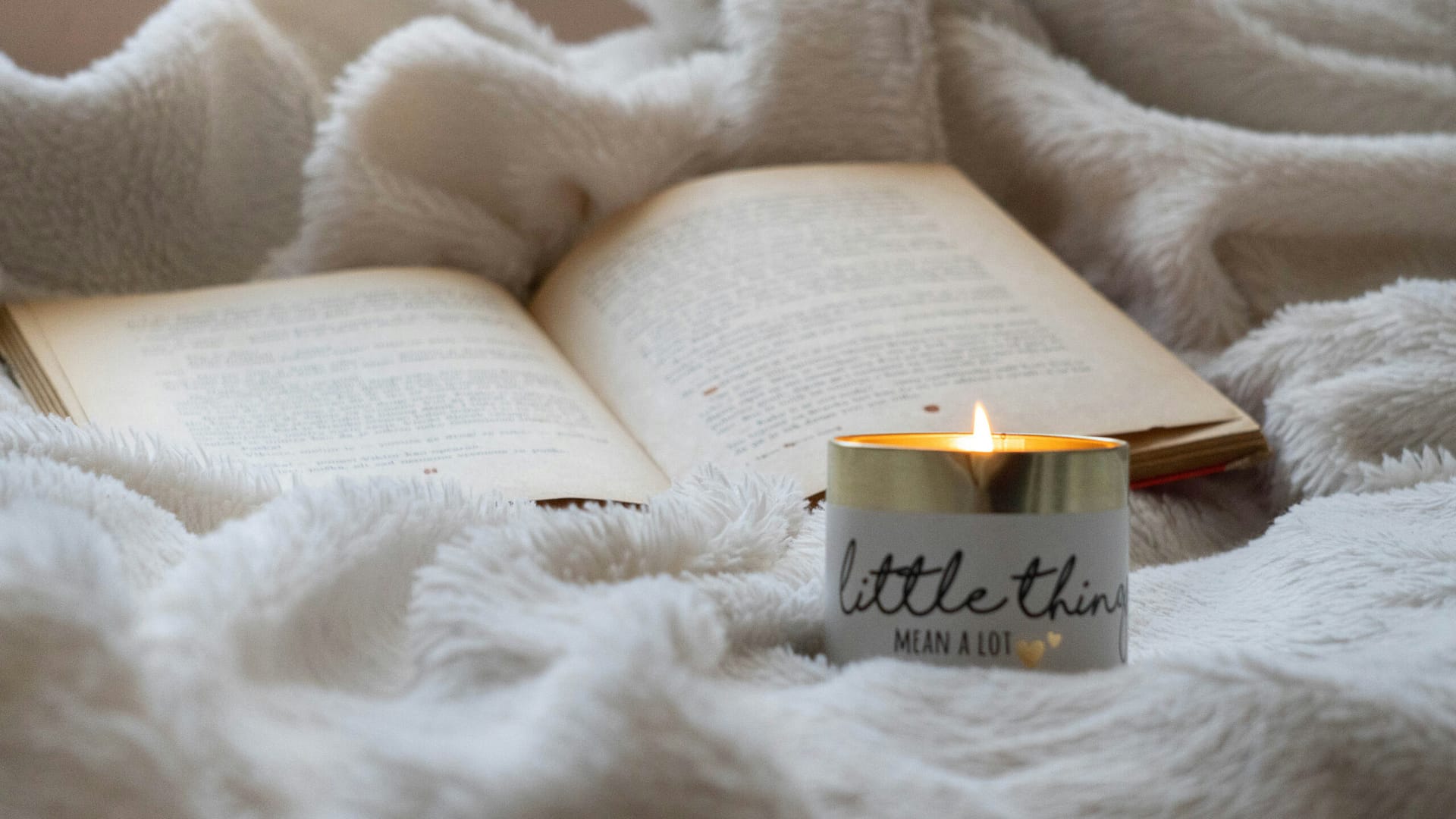 A blanket, a book and a candle that says "little things mean a lot". Perfect small comforts.