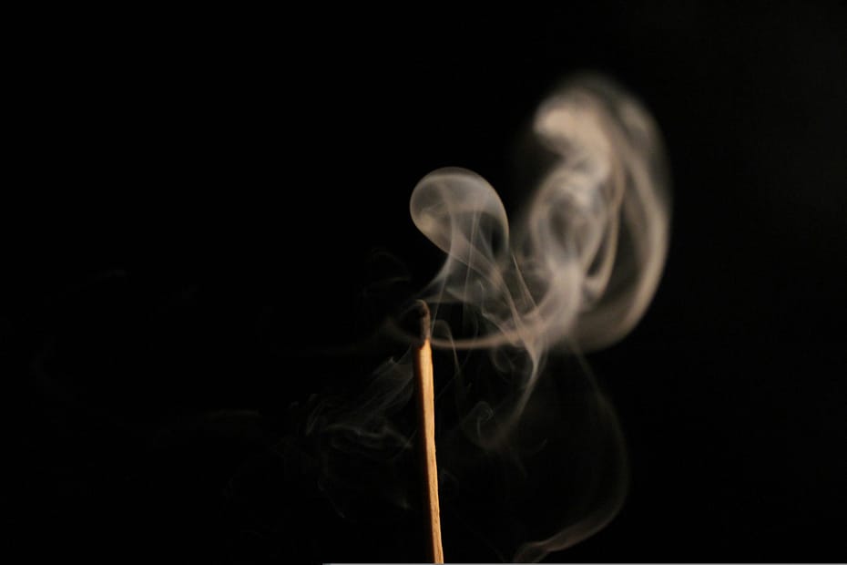 Smoke rises from an extinguished match. A metaphor for outgrowing your passion.