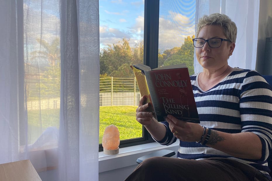 Em sits in her office by the window, pretending to read The Killing Kind by John Connolly. Another cracker from Wendy's bookshelf.