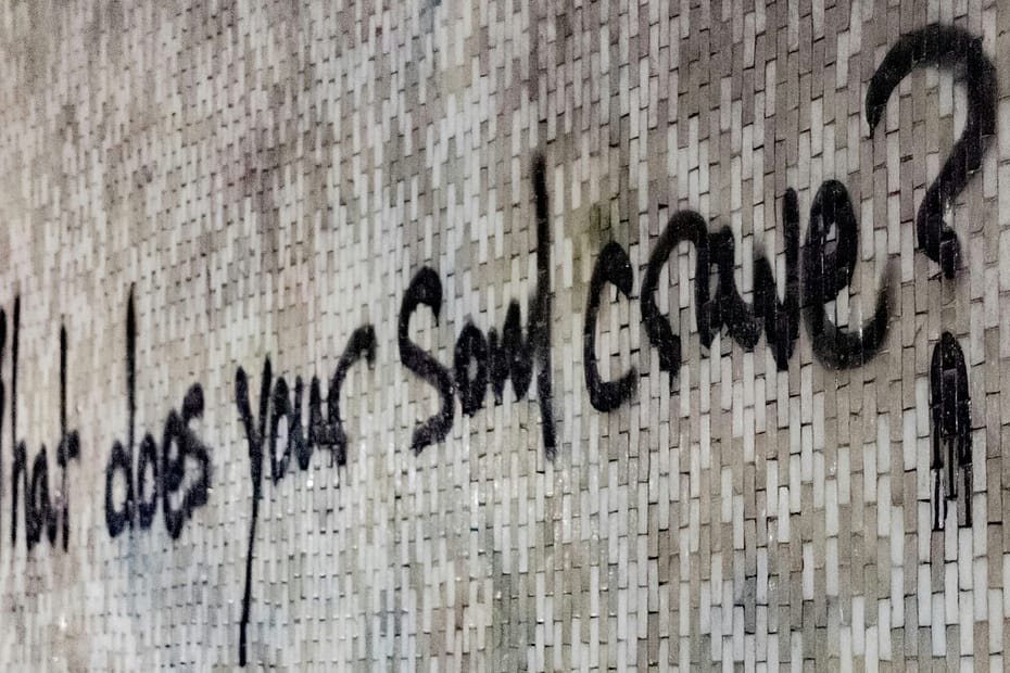 Image shows a wall with graffiti written on it saying "what does your soul crave?" When was the last time you asked yourself "what do I want?"